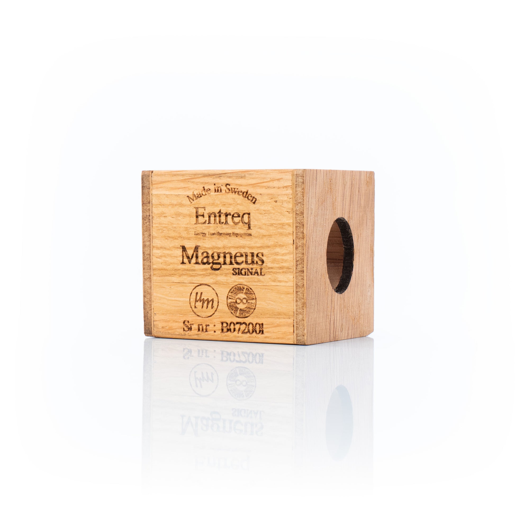 Entreq Magneus Signal electromagnetic field transformer in natural wood and metal finish, shown on a cable