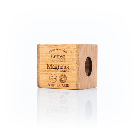 Entreq Magneus Signal electromagnetic field transformer in natural wood and metal finish, shown on a cable